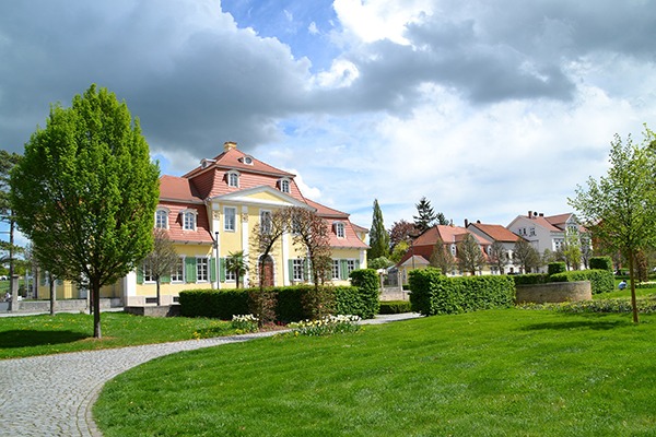 Blick auf schicke Häuser mit viel Grün im Vordergrund